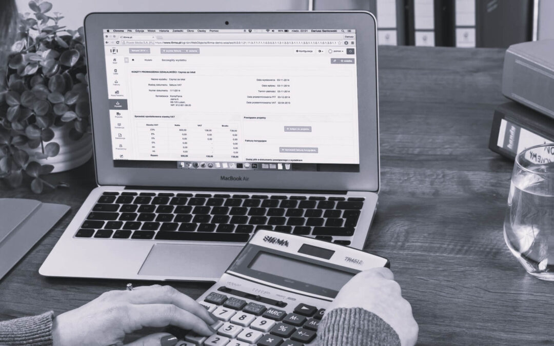 Working on MacBook Air with calculator on table